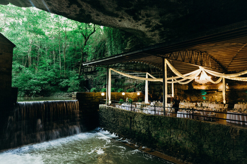 Lost River Cave wedding venue in Bowling Green, Kentucky with waterfall and chandelier in the background.